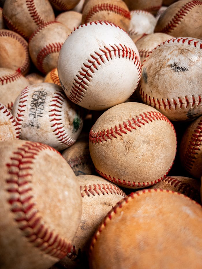 A collection of aged baseballs with visible wear, perfect for sports-themed imagery.